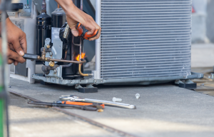 HVAC technician repairing an air conditioning unit in Woodridge, Illinois